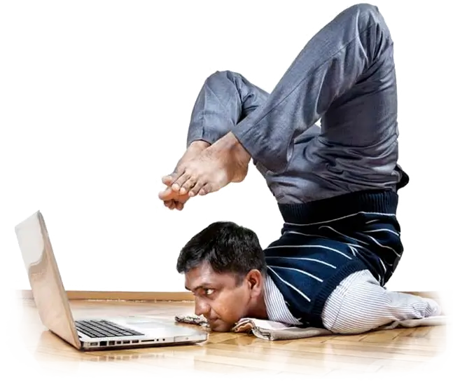 Flexible man doing a backbend infront of his laptop