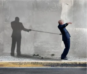 Man being held back metaphorically by a shadow