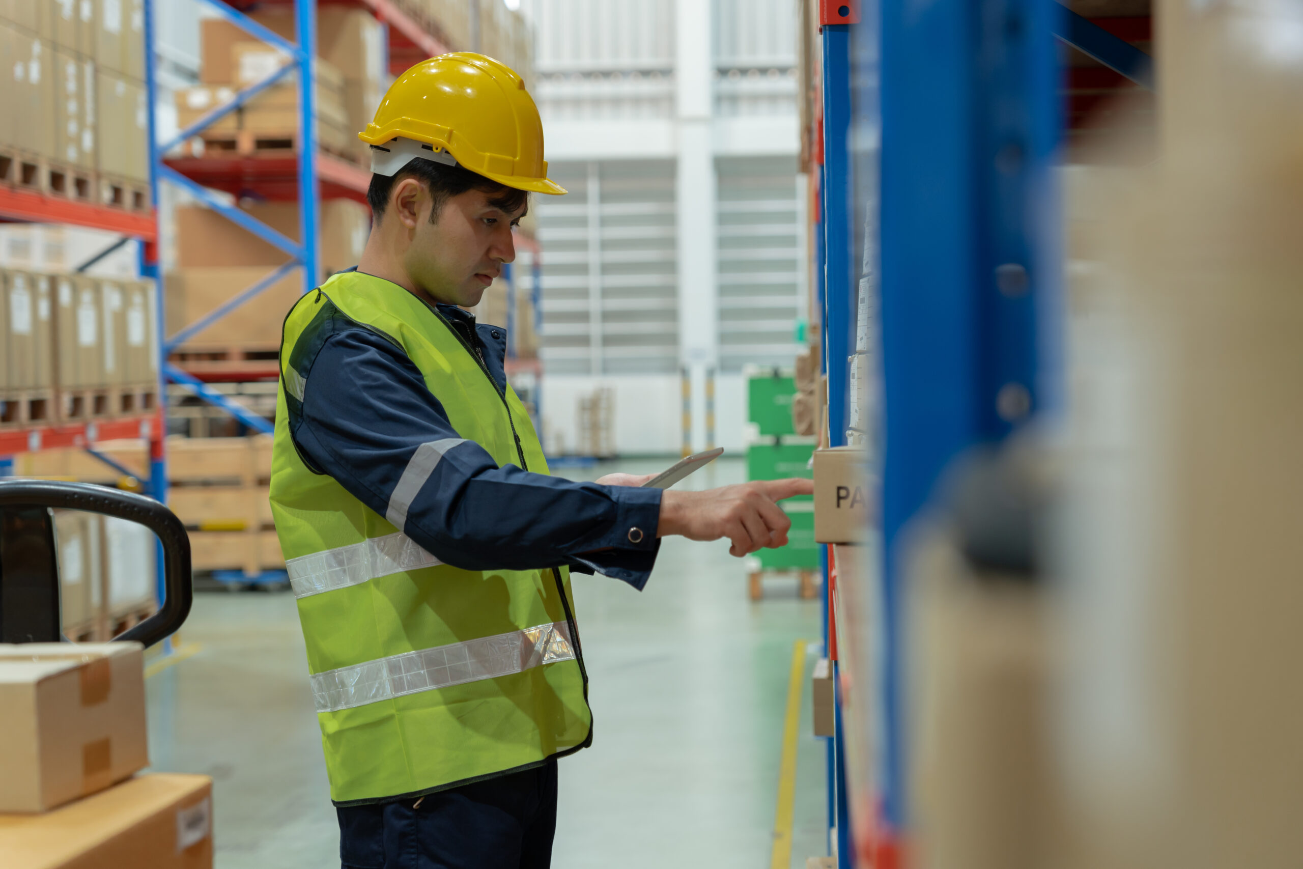 Warehouse worker pick box goods in inventory and check stock pro